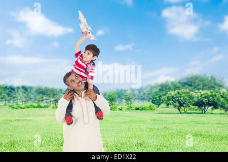 indian grandfather and grandson playing toy Airplane Stock Photo