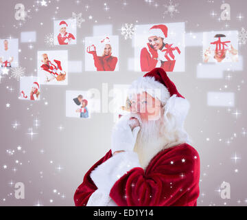 Composite image of santa is thinking about something Stock Photo