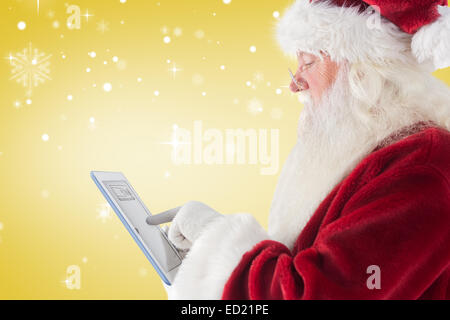 Santa uses a tablet pc Stock Photo