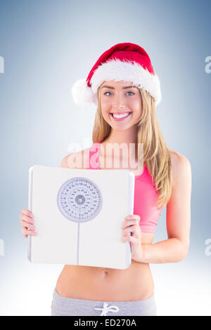 Festive fit blonde showing scales Stock Photo - Alamy