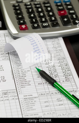 Desktop with calculator, ledger, pencil and tape with numbers Stock Photo