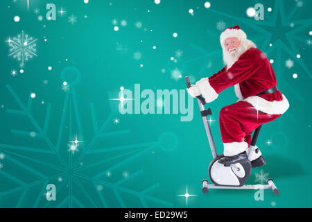 Composite image of santa uses a home trainer Stock Photo