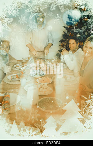 Composite image of happy grandfather carving the christmas turkey Stock Photo