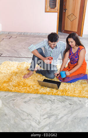2 indian married couple home laptop working Stock Photo