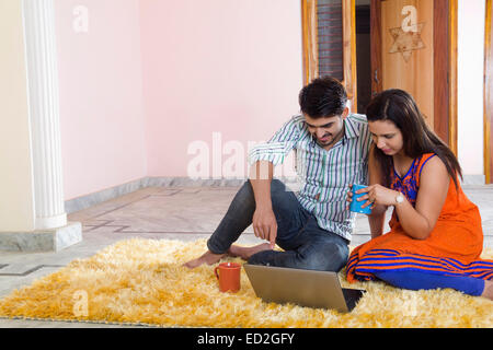 2 indian married couple home laptop working Stock Photo
