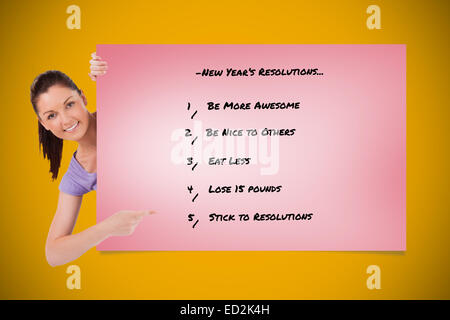 Composite image of good looking female pointing at a list while standing Stock Photo