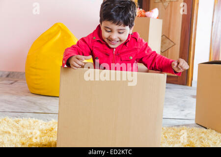 1 indian child boy home fun Carton box Stock Photo