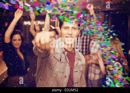 Composite image of stylish man smiling and dancing Stock Photo