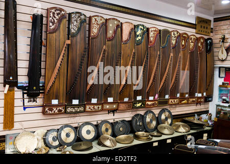 Guzheng, guqin and gongs at a music instrument store in Shanghai, China. Stock Photo