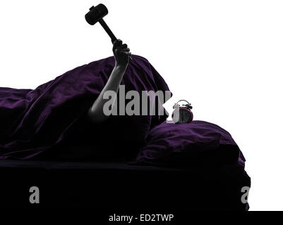 one person smashing alarm clock in bed waking up smashing alarm clock silhouette studio on white background Stock Photo