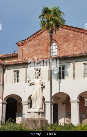 statue of unknown monk in the courtyard of church San Francesco. Lucca, Tuscany, Italy. Stock Photo