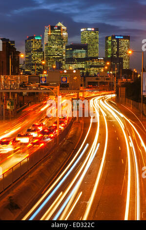 Traffic on A102 Blackwall Tunnel Approach with Canary Wharf skyscrapers in the background, London England United Kingdom UK Stock Photo