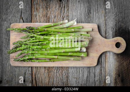 Fresh Asparagus on Rustic Wood Cutting Board Background Stock Photo