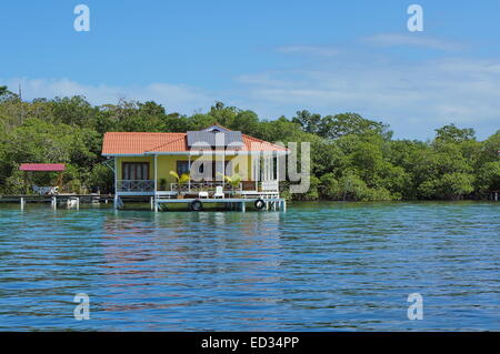 Off grid house over the sea with solar panels on the roof, Caribbean, Panama Stock Photo