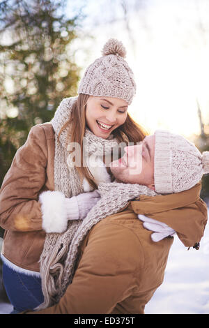 Amorous and joyful couple having fun in winter outdoors Stock Photo