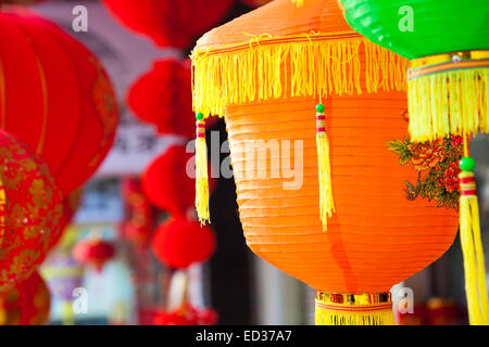 Colorful Chinese paper lanterns hanging in a street martket prepared for Chinese spring festival. Stock Photo