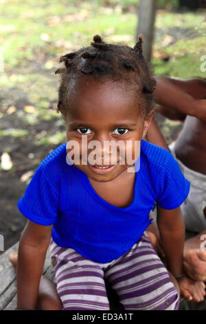 MELVERT,VANUATU-OCTOBER 6, 2014: Pretty girl poses for the photographer at the entrance to her home on October 6, in Ambrym-Vanu Stock Photo
