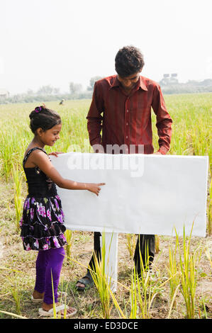 Surprised kid looking away, pointing finger on isolated studio ...