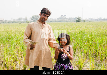 indian rural farmer and child Farm saving money credit card Stock Photo