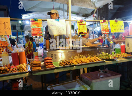 Thai Sausages, kebabs, skewers, satay, offered by vendor. Thai street night market, Krabi, Thailand. Asia. Stock Photo