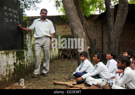 indian rural Teacher man Teaching Children Stock Photo
