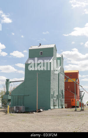 Nanton, Alberta, grain silos elevators alongside the rail track disused brightly painted wooden Stock Photo