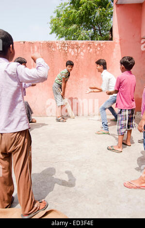 indian rural group children boys Playing cricket Stock Photo