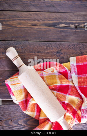 wooden rolling pin and napkin on a table Stock Photo