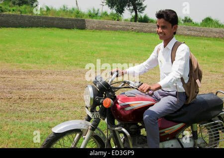 1 indian rural boy School Student Riding bike Stock Photo