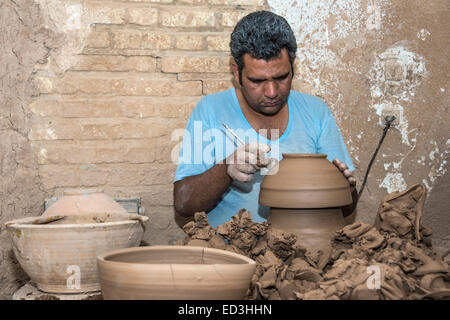 Potter working at his shop in the city of Mebod, Province of Yazd, Iran Stock Photo