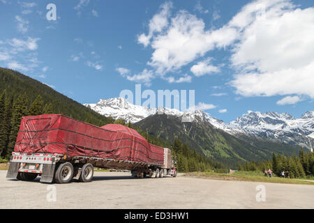 Rogers Pass, BC Canada, Peterbilt 379 parked with load of covered lumber on trailer Stock Photo