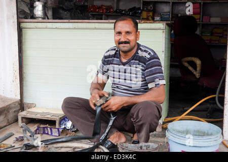 1 indian rural man Cycle Tyre Mechanic Stock Photo