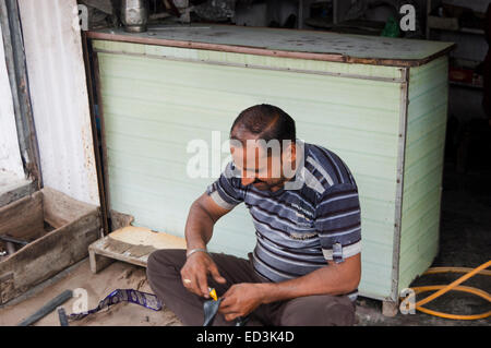 1 indian rural man Cycle Tyre Mechanic Stock Photo