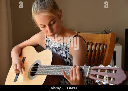 Young female student playing guitar Stock Photo