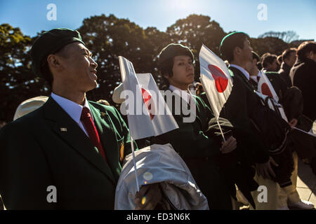 Thousands of Japanese people, including right-wing nationalists, come every year to greet their Emperor on the day of his birthday. Emperor Akihito, accompanied by Empress Michiko and all the members of his family, appears several times in a large window of the Imperial Palace to give his speech. While other people greeted the Emperor silently by waving little Japanese flags, nationalists sang the national anthem and screemed 'Banzai' to demonstrate their affilitation. © Martin Hladik/AFLO/Alamy Live News Stock Photo