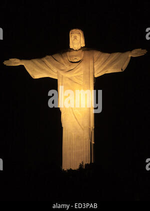 (141226) -- RIO DE JANEIRO, Dec. 26, 2014 (Xinhua) -- The statue of Christ the Redeemer is illuminated with yellow light marking the Easter in Rio de Janeiro, Brazil, April. 19, 2014. Christ the Redeemer is a famous statue of Jesus Christ in Rio de Janeiro, Brazil, created by French sculptor Paul Landowski and built by the Brazilian engineer Heitor da Silva Costa, in collaboration with the French engineer Albert Caquot. The height of the statue reaches 30 meters and its arms stretch 28 meters wide. Under the statue, there is a small chapel dedicated to Our Lady Aparecida, the patron saint of Stock Photo