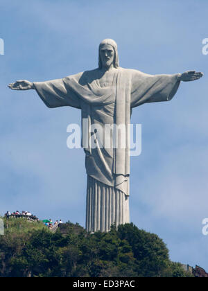 (141226) -- RIO DE JANEIRO, Dec. 26, 2014 (Xinhua) -- Visitors are seen at the deck under the statue of Christ the Redeemer in Rio de Janeiro, Brazil, April 22, 2014. Christ the Redeemer is a famous statue of Jesus Christ in Rio de Janeiro, Brazil, created by French sculptor Paul Landowski and built by the Brazilian engineer Heitor da Silva Costa, in collaboration with the French engineer Albert Caquot. The height of the statue reaches 30 meters and its arms stretch 28 meters wide. Under the statue, there is a small chapel dedicated to Our Lady Aparecida, the patron saint of Brazil. The color Stock Photo