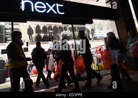Aberystwyth, Wales, UK. 26th December, 2014.   Hundreds of people in Aberystwyth queued from the early hours in order to be amongst the first through the doors at the Next department  store  Boxing Day sales. The shop opened at 6am Credit:  keith morris/Alamy Live News Stock Photo