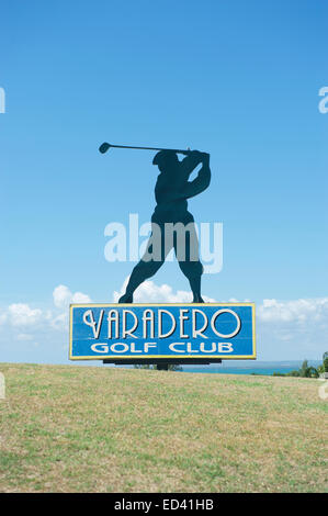 VARADERO, CUBA - MAY 25, 2011: Silhouette of golfer stands atop a sign for the Varadero Golf Club. Stock Photo