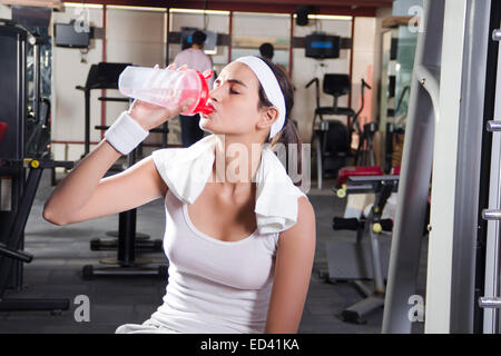 1 indian Sports lady gym Drinking water Stock Photo