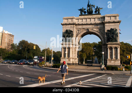 Men with dogs in Grand Army Plaza. NYC. Grand Army Plaza comprises the northern corner and the main entrance of Prospect Park in Stock Photo