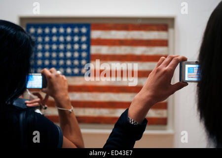 MOMA Museum. Museum goers contemplate ':American Flag' by the artist Jasper Johns at the Museum of Modern Art in New York City. Stock Photo