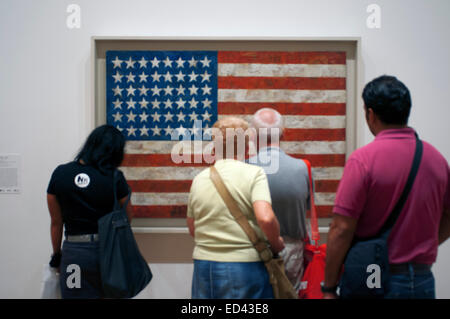 MOMA Museum. Museum goers contemplate ':American Flag' by the artist Jasper Johns at the Museum of Modern Art in New York City. Stock Photo