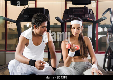 indian sports Trainer and lady Dumbbell Exercise Stock Photo