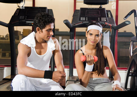 indian sports Trainer and lady Dumbbell Exercise Stock Photo