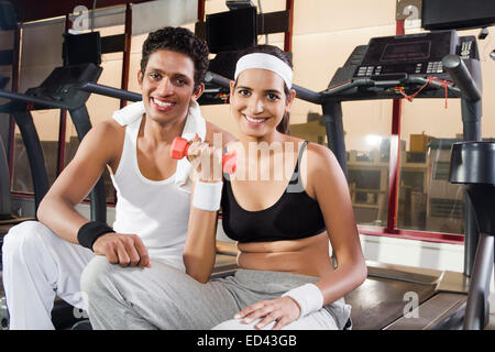 indian sports Trainer and lady Dumbbell Exercise Stock Photo