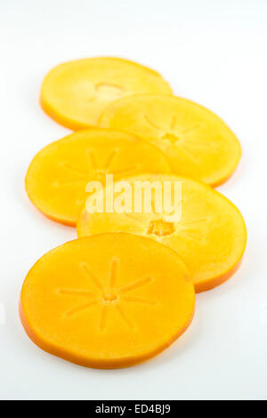 group of orange persimmon slices isolated on white background