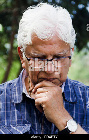 indian Old man park thinking Stock Photo