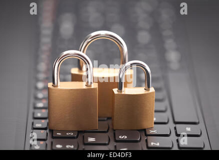 Internet security concept with padlocks on laptop keyboard Stock Photo