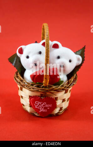 A cute white teddy bears with with rose in basket. Stock Photo